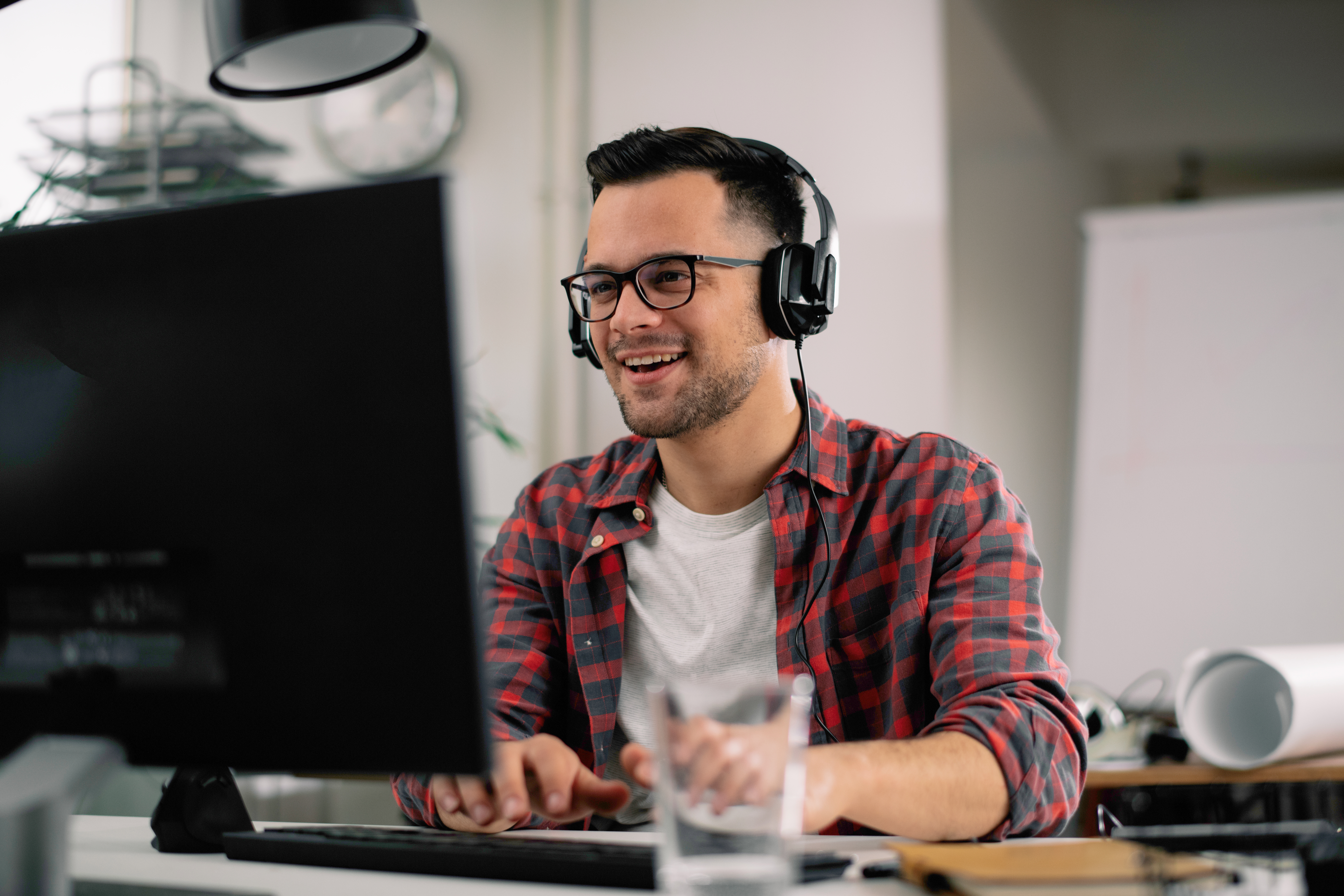 Businessman on video call. Handsome man in office with headphone